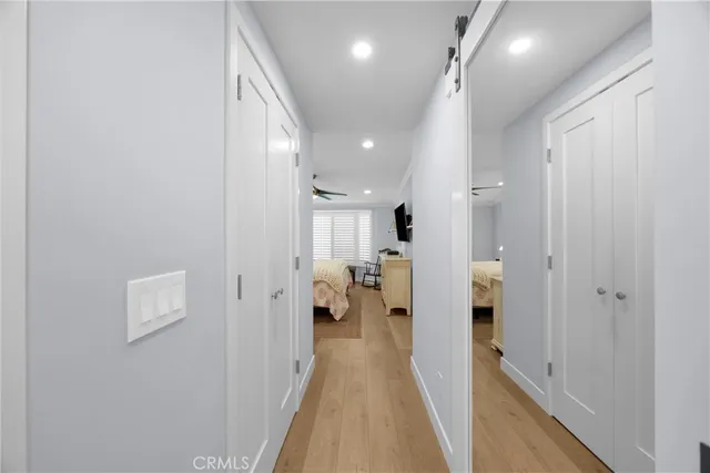 a view of a hallway with a livingroom and a chandelier