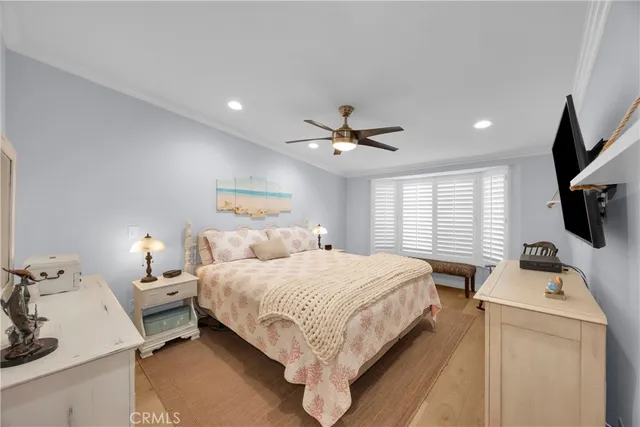 a bedroom with a bed tv and a window