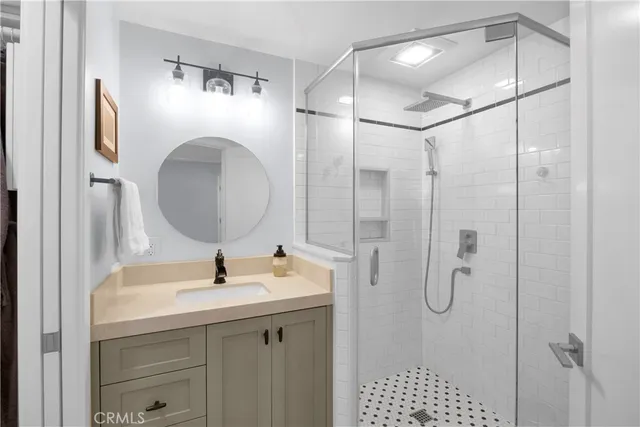 a bathroom with a sink vanity and a mirror