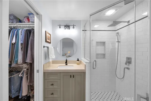 a bathroom with a granite countertop sink a toilet and shower