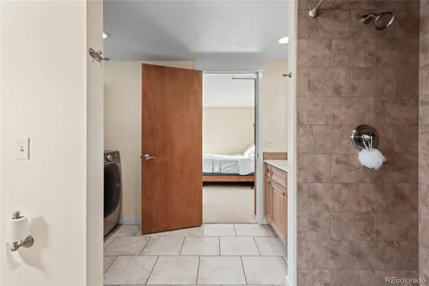 a view of bathroom with a sink and washer dryer