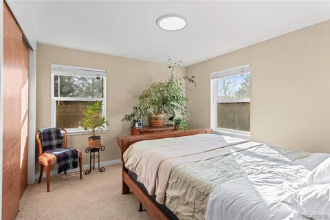 a bedroom with a bed and a painting on the wall