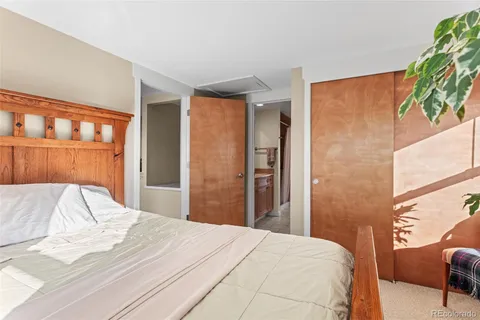 a bedroom with a bed and a television