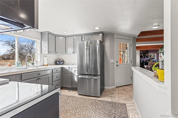 a kitchen with a refrigerator and a sink