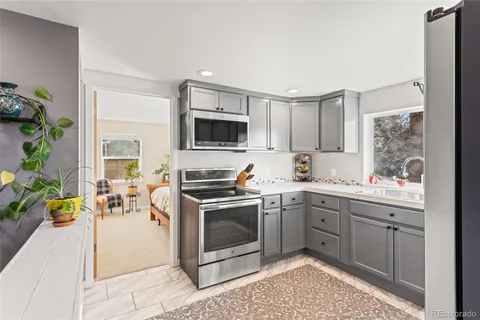 a kitchen with a sink stove and microwave