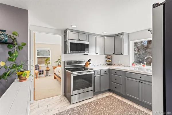 a kitchen with a sink stove and microwave