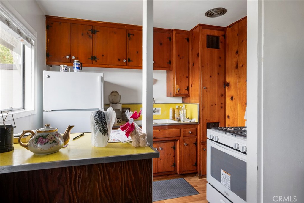 317 Sheldon Street El Segundo, CA 90245 - Photo 12 of 24 a kitchen with a sink and a refrigerator