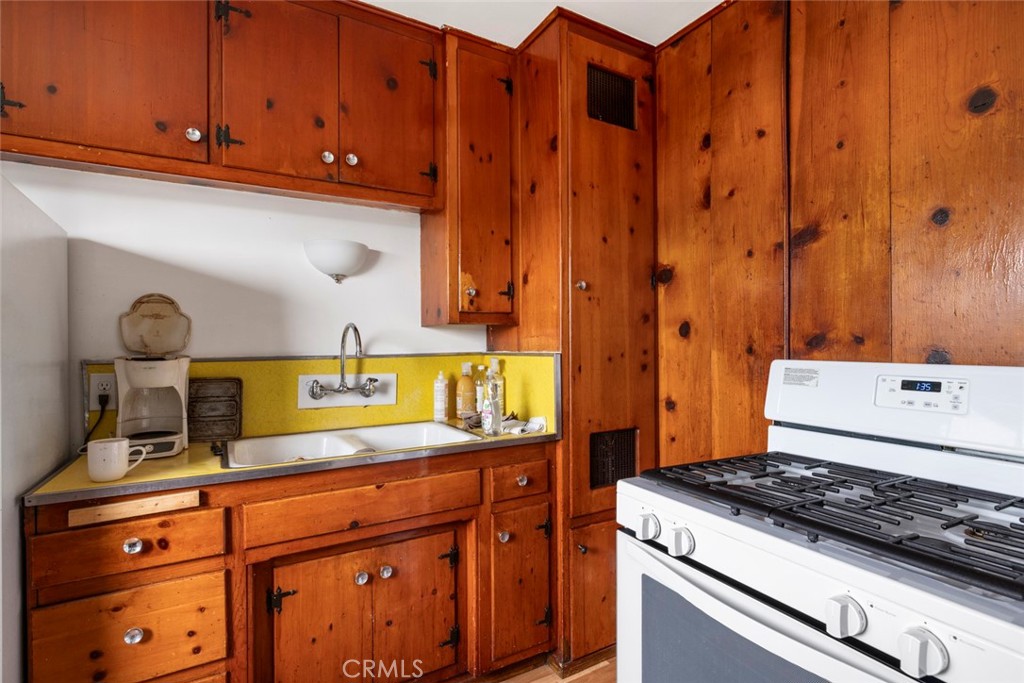 317 Sheldon Street El Segundo, CA 90245 - Photo 13 of 24 a kitchen with granite countertop a stove and cabinets