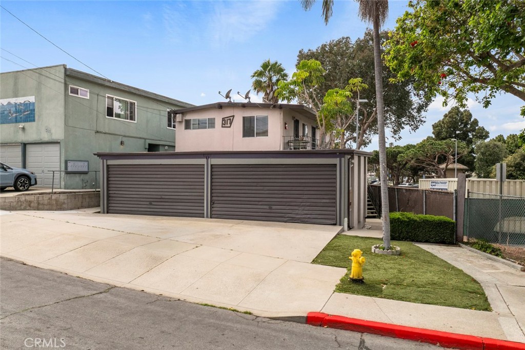317 Sheldon Street El Segundo, CA 90245 - Photo 4 of 24 a view of house with backyard and trees