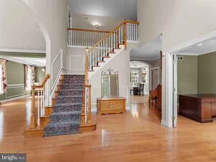 a view of entryway and hall with wooden floor