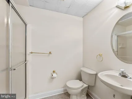 a white toilet sitting next to a bathroom sink