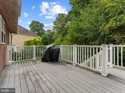 a view of a wooden deck with a yard