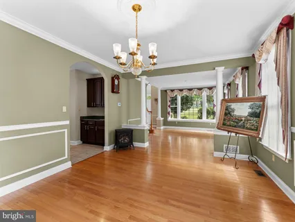 a view of an empty room with window wooden floor and a fireplace