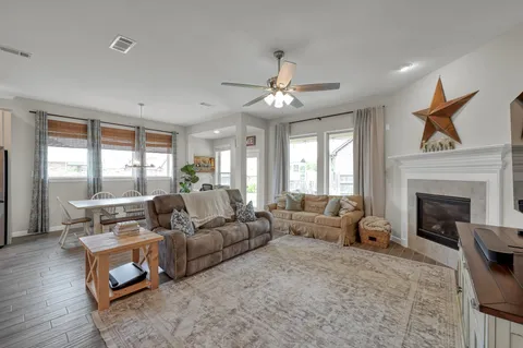 a living room with furniture and a fireplace