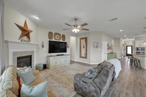 a living room with furniture a flat screen tv and a fireplace