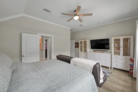 a bedroom with furniture and a flat screen tv