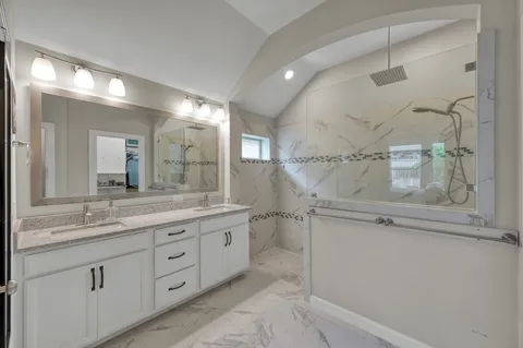 a bathroom with a granite countertop sink mirror and double