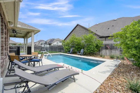 a view of a swimming pool with a patio