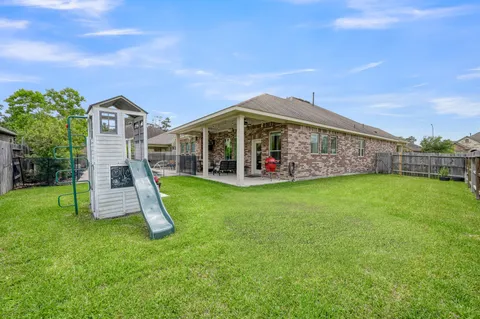 a view of a house with a backyard