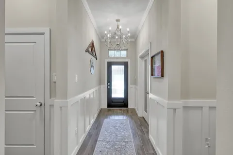 a view of a hallway view with wooden floor and staircase