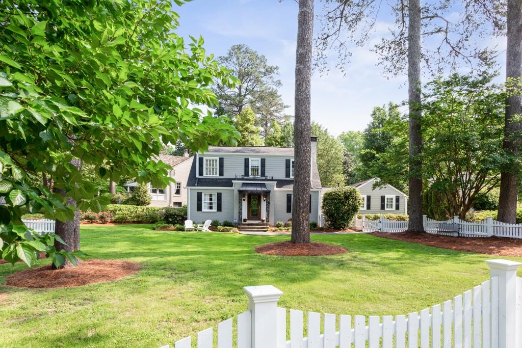 506 East Wesley Road Northeast Atlanta, GA 30305 - Photo 1 of 1 a view of house with garden and tall trees
