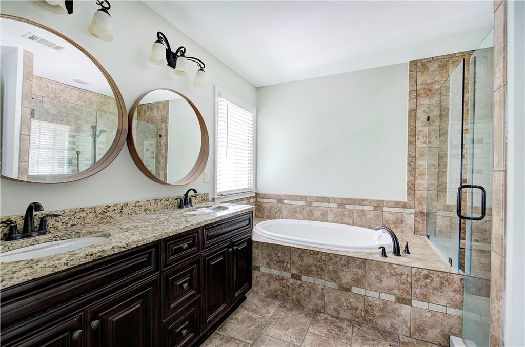 561 Holland Road Dallas, GA 30157 - Photo 26 of 48 a bathroom with a granite countertop bathtub sink and mirror