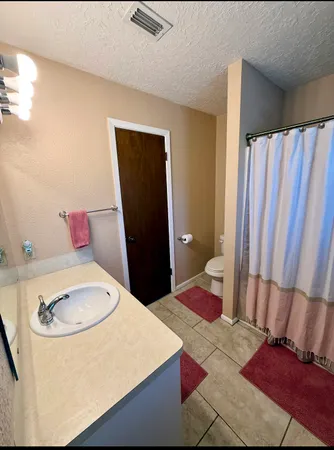 a bedroom with a bed and a chair