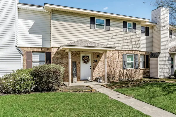 a view of a house with yard and garden