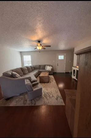 a living room with furniture and a chandelier