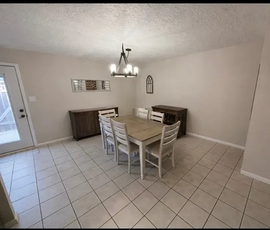 a dining room with furniture and chandelier