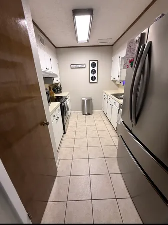a view of a livingroom with an empty space and a window