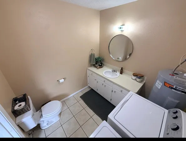a bathroom with a toilet mirror and vanity