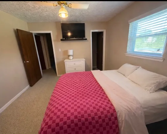 a bedroom with a bed and a flat screen tv