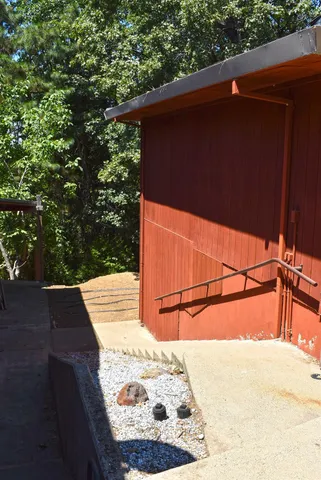 a kitchen with granite countertop a stove a sink and a window