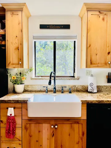 a view of a room with furniture cabinet and a ceiling fan