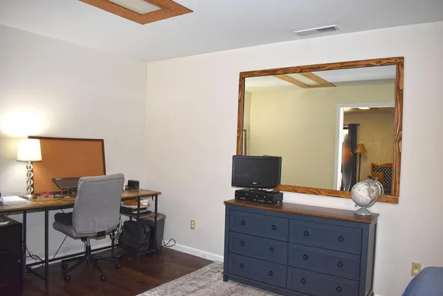 a view of a wooden deck next to a yard