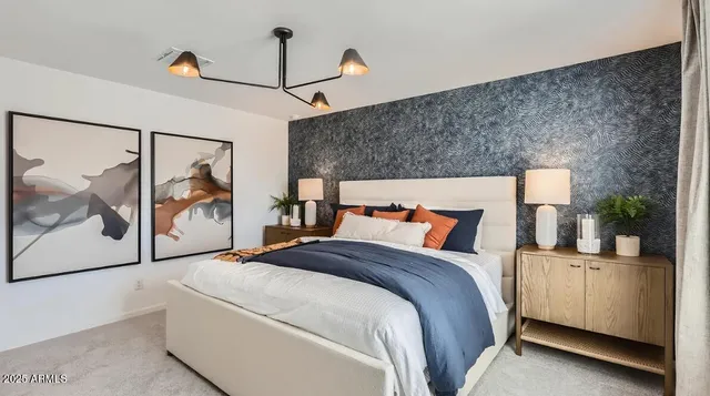 a bedroom with a large bed and a painting on the wall