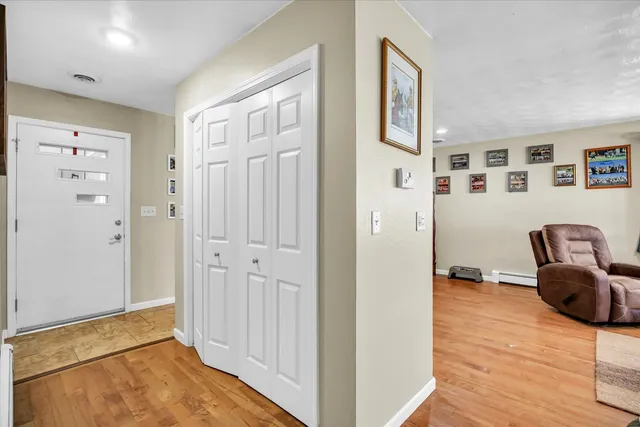 a kitchen with stainless steel appliances granite countertop a stove a sink dishwasher and cabinets with wooden floor