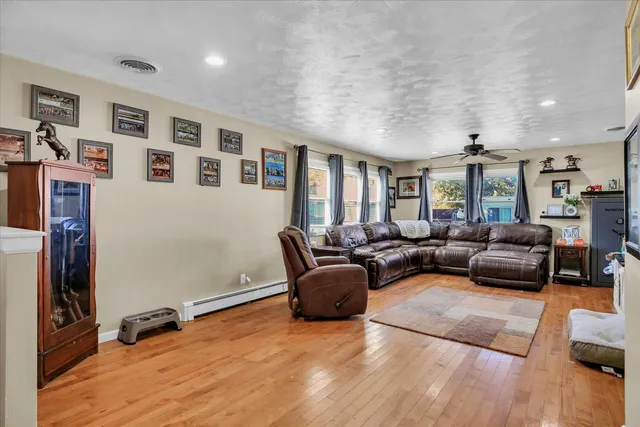 a bathroom with a double vanity sink a large mirror and a shower