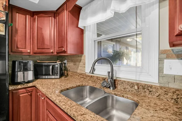 a view of a patio with a table and chairs under an umbrella