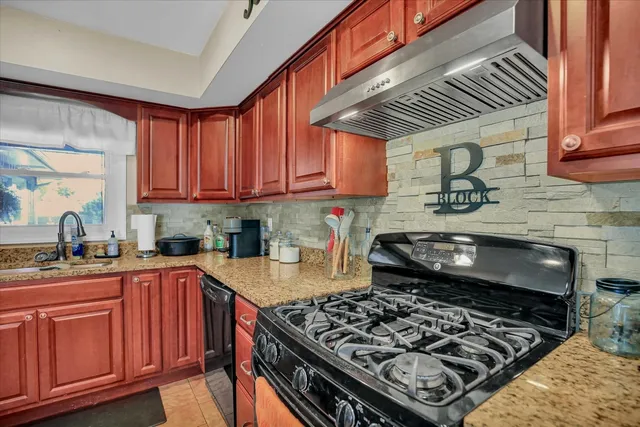 an aerial view of a house with garden space and street view