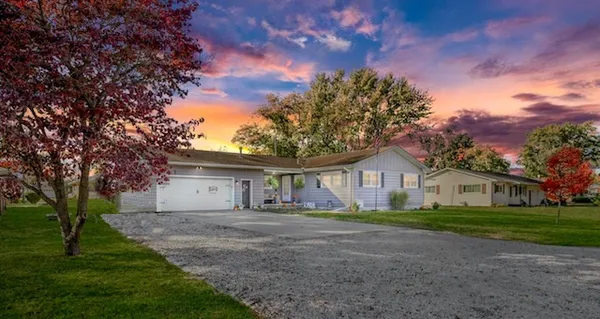 a front view of house with yard and green space