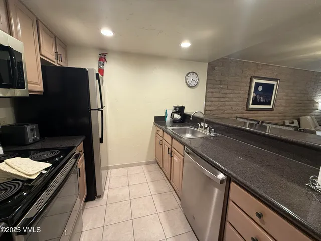 a kitchen with a sink appliances and cabinets