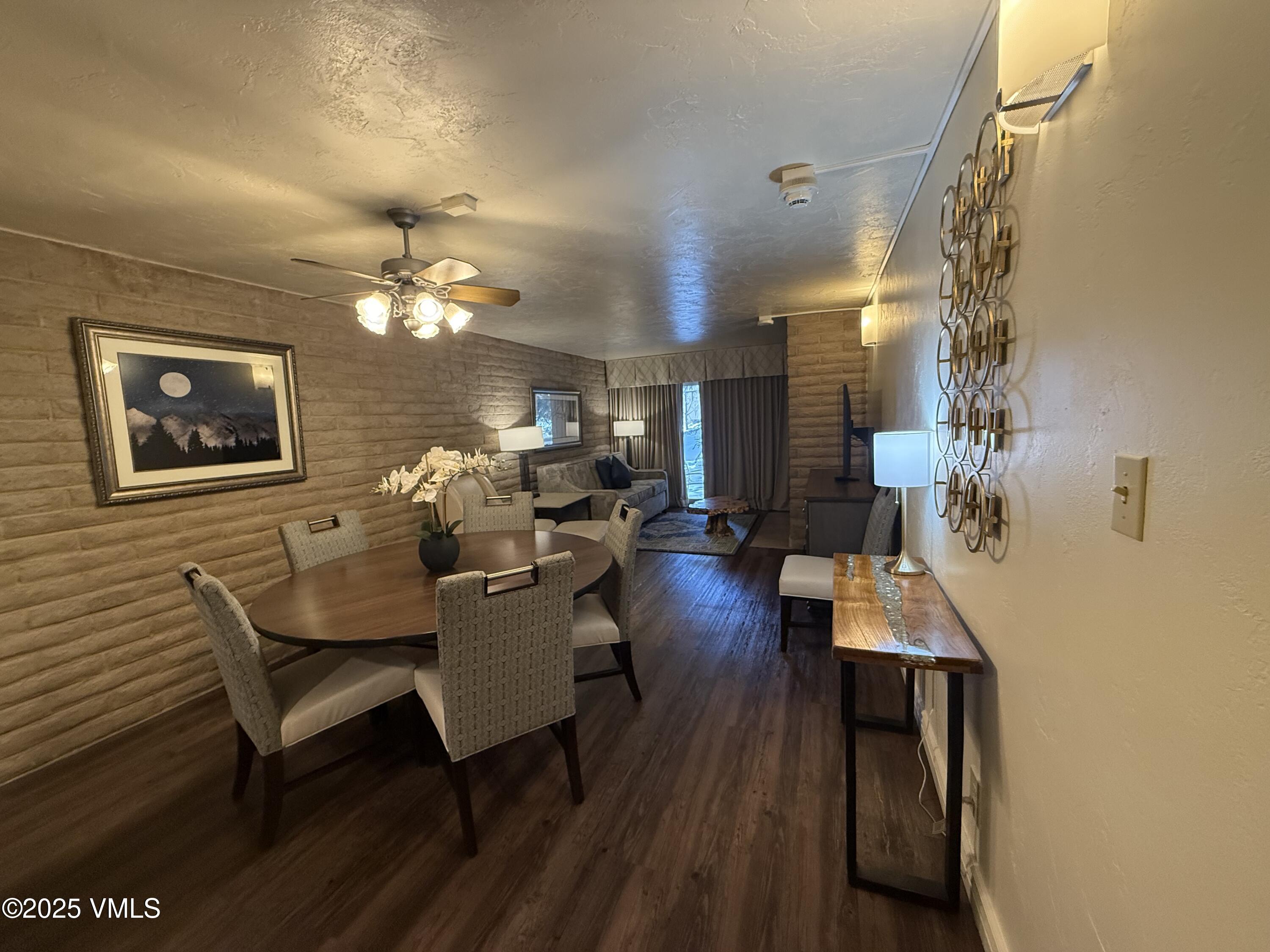1020 Vail View Drive, Unit 220139 Vail, CO 81657 - Photo 3 of 23 a living room with furniture and a chandelier