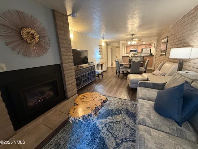 a living room with furniture a flat screen tv and a fireplace