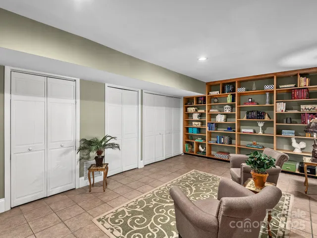 a livingroom with a bookshelf and a chair