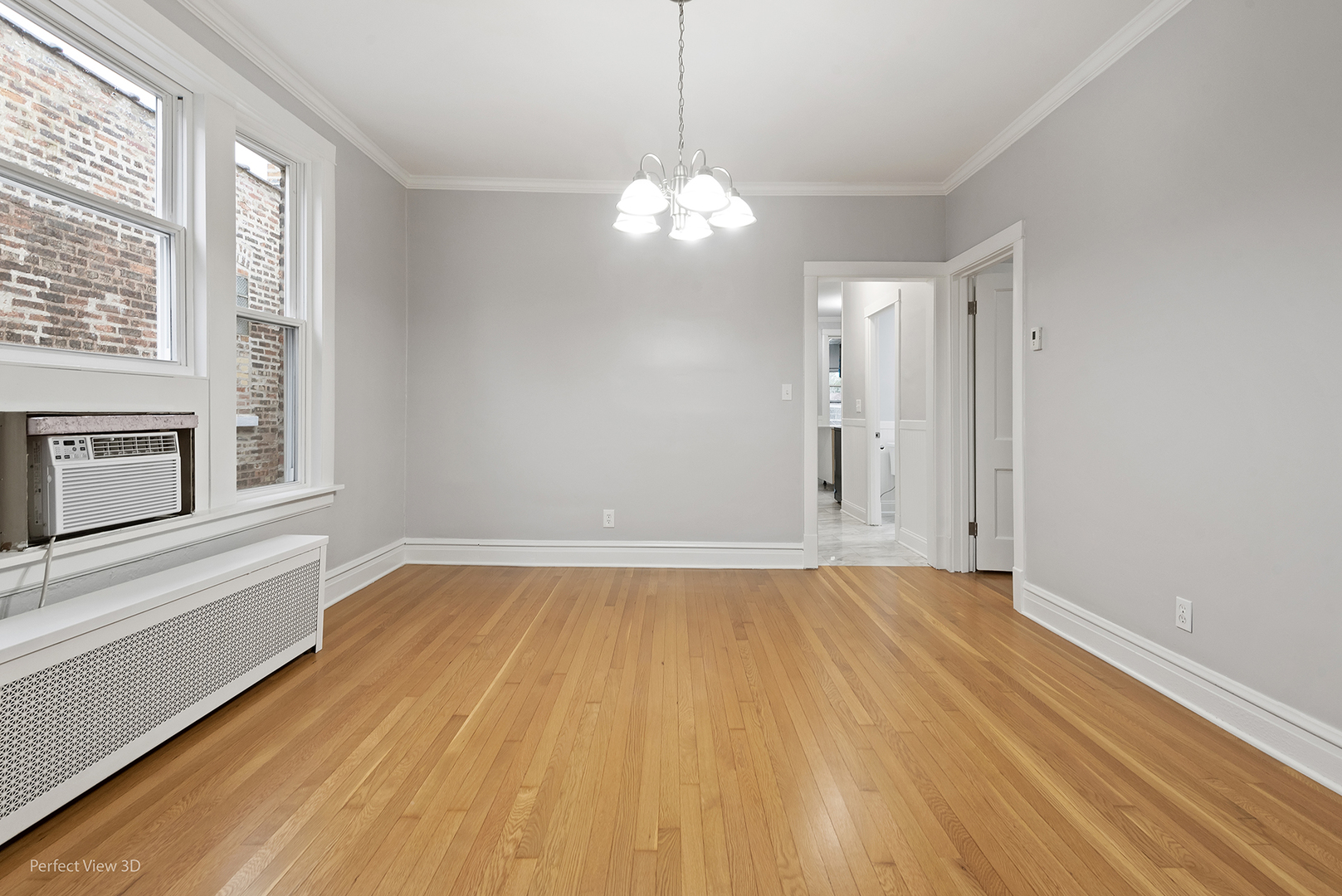 2108 Highland Avenue Berwyn, IL 60402 - Photo 24 of 32 a view of an empty room with a window and wooden floor