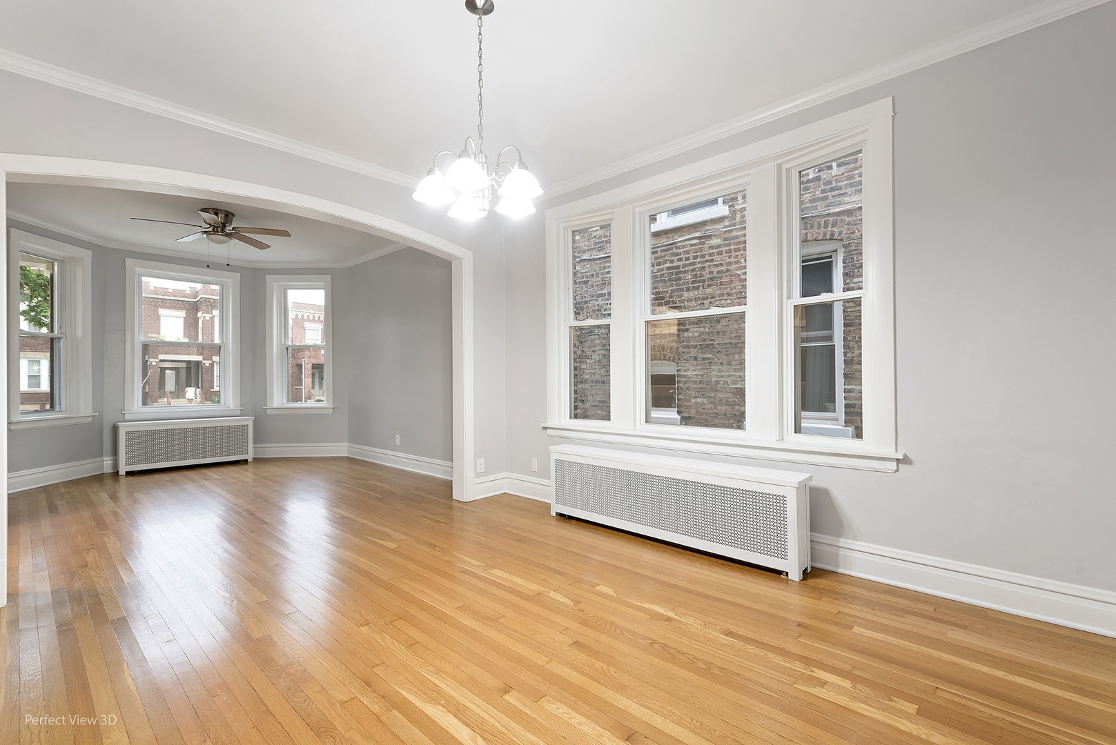 2108 Highland Avenue Berwyn, IL 60402 - Photo 5 of 32 a view of an empty room with wooden floor and a window