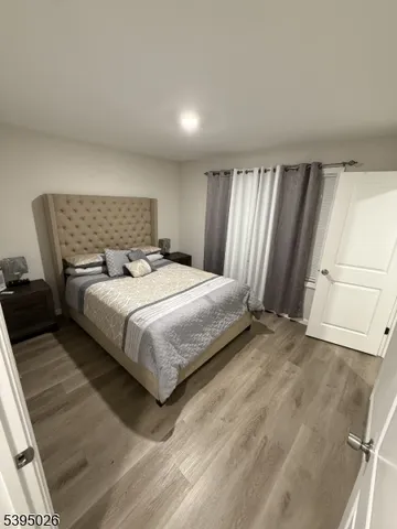 a bedroom with a bed and a mirror