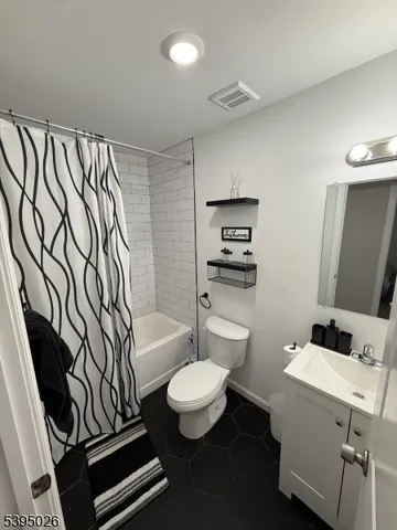 a bathroom with a toilet a sink and a mirror